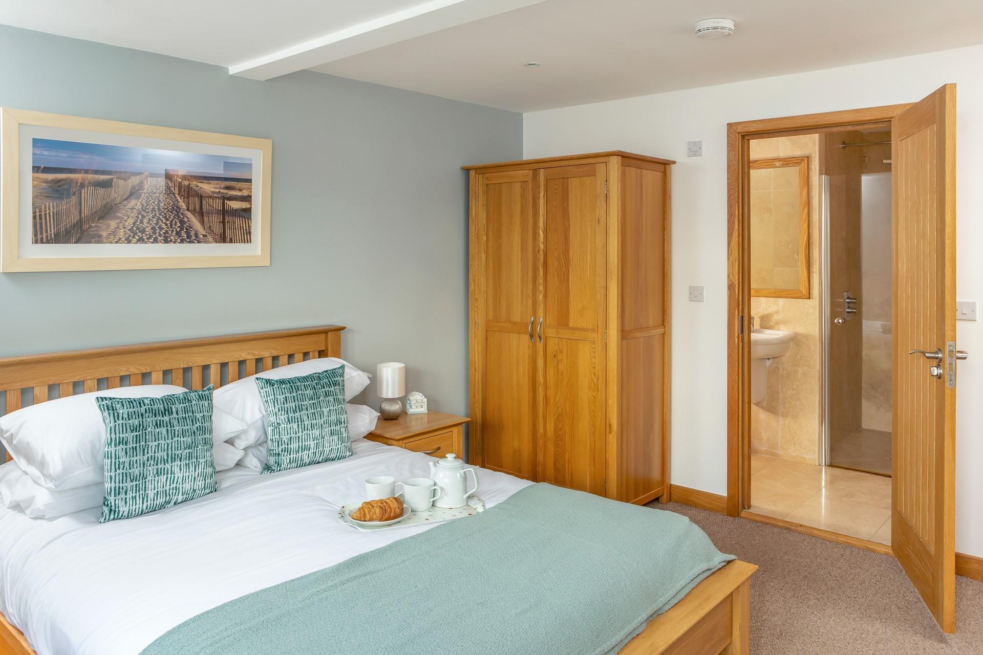 Bedroom 1 benefits from an en suite shower room and comfortable king bed.
