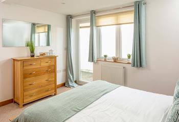 A door from bedroom 1 opens out to a small lower patio, an ideal spot for keeping your beach gear.