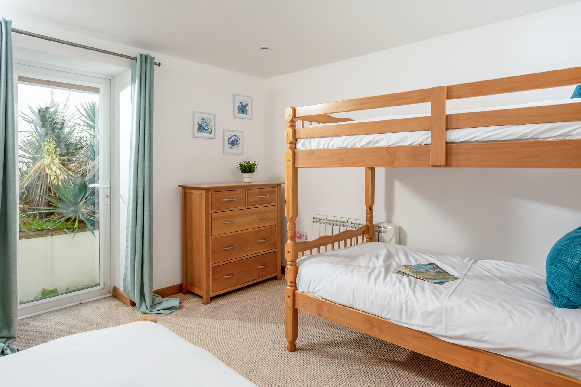 A door leads from the fourth bedroom to a small patio space, which can be useful for leaving sandy beach bits.