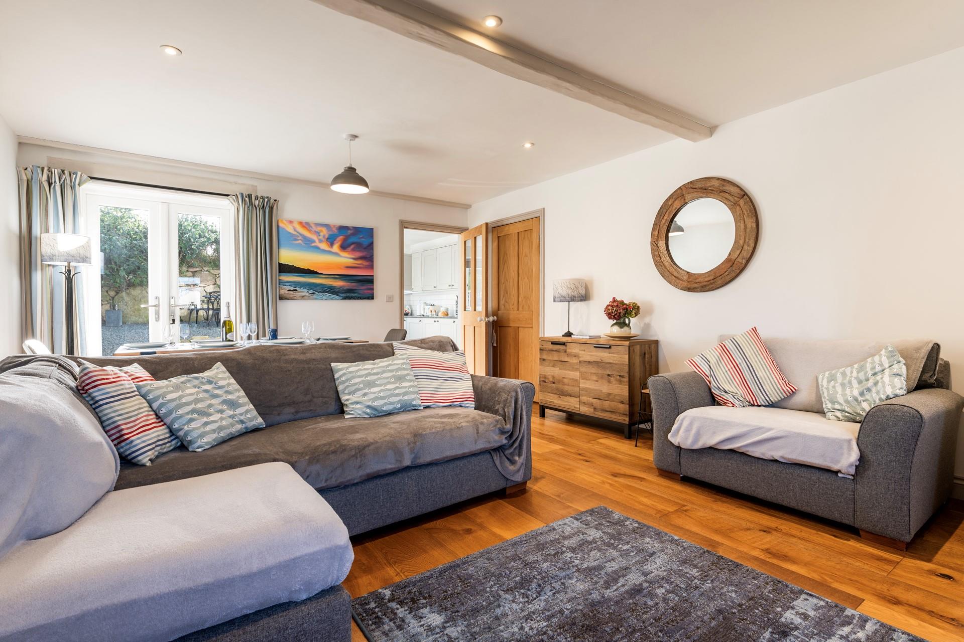 Relax in the sitting room with its calming grey colour palette.