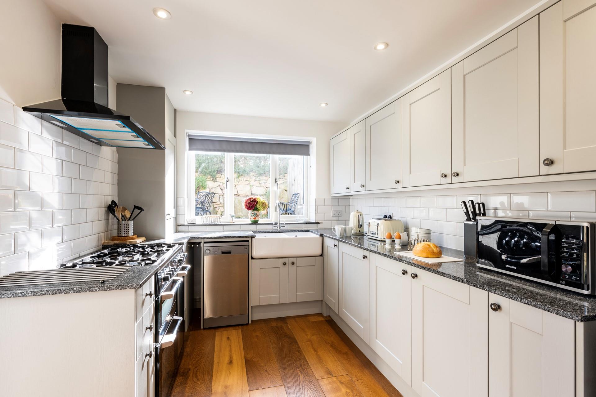 The kitchen is stylish and fully equipped for cooking up a storm.