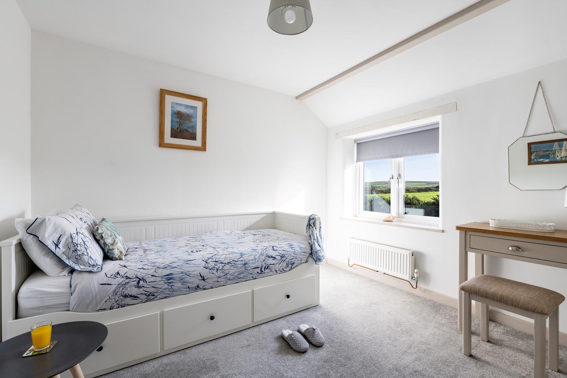 Bedroom 2 has a single-day bed with a trundle underneath for flexible sleeping arrangements.