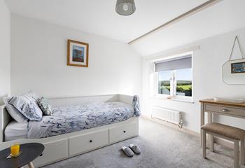 Bedroom 2 has a single-day bed with a trundle underneath for flexible sleeping arrangements.