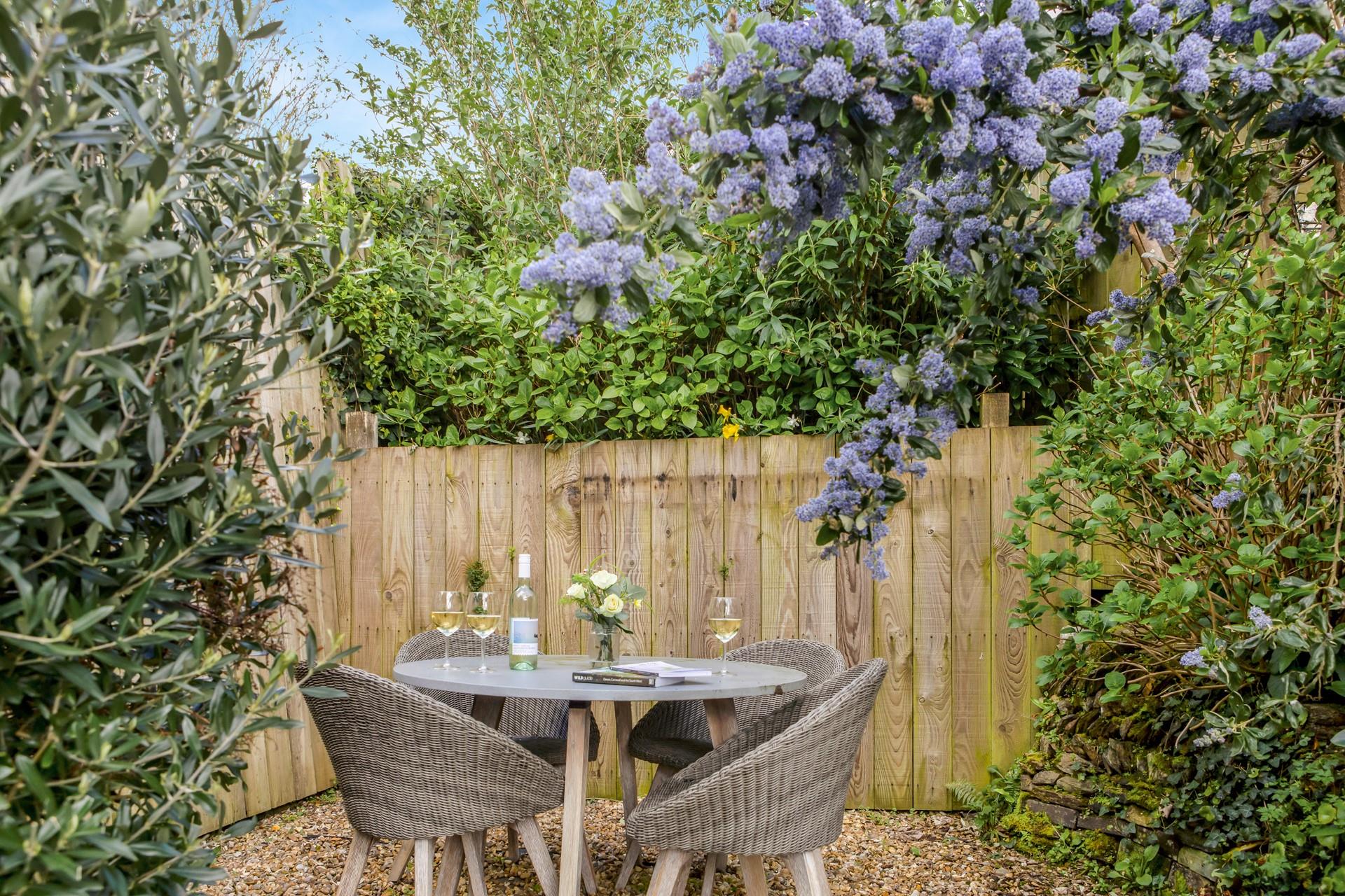 Beautiful wisteria blooms in the garden making the perfect spot for a glass of wine.