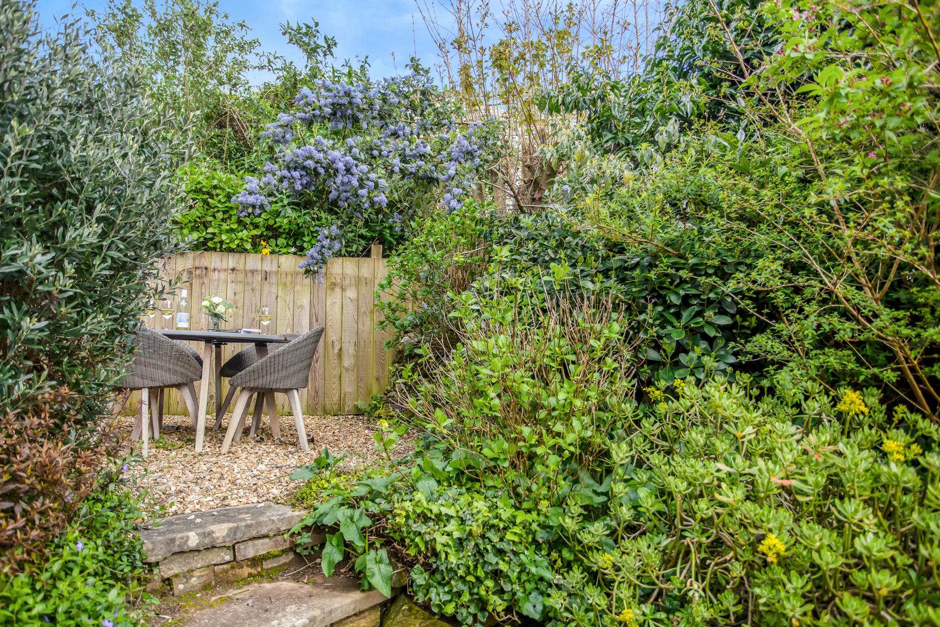 A sheltered spot between the trees in the garden for a glass of wine.