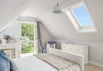 Light floods the bedroom through the skylight in the cosy top bedroom.