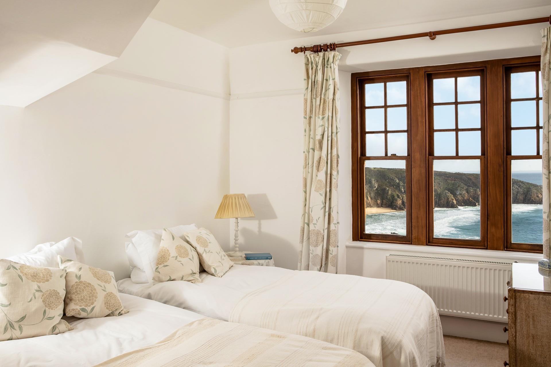 The cosy twin room is a coastal sanctuary, boasting more of the stunning seascapes.