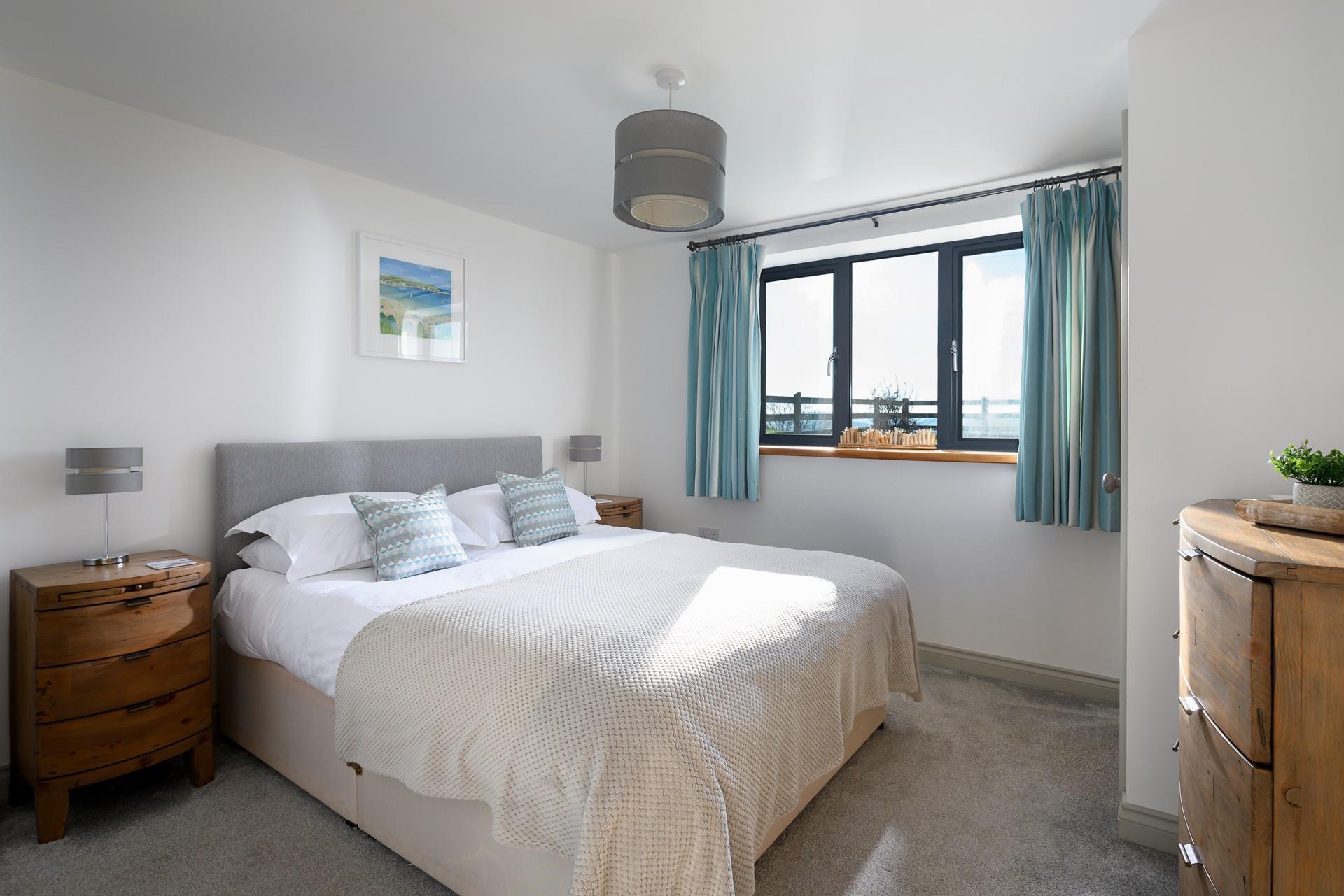 Sleep well in the soft hues and contemporary feel of the bedroom.