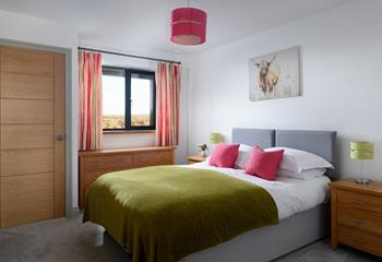 A bright and cheerful bedroom, we love the highland cow artwork!