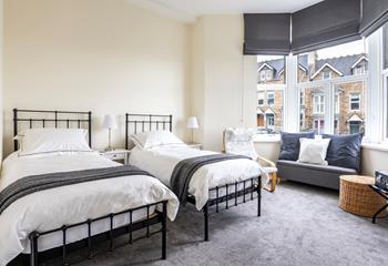 Bedroom 1 is filled with light from the large bay window.