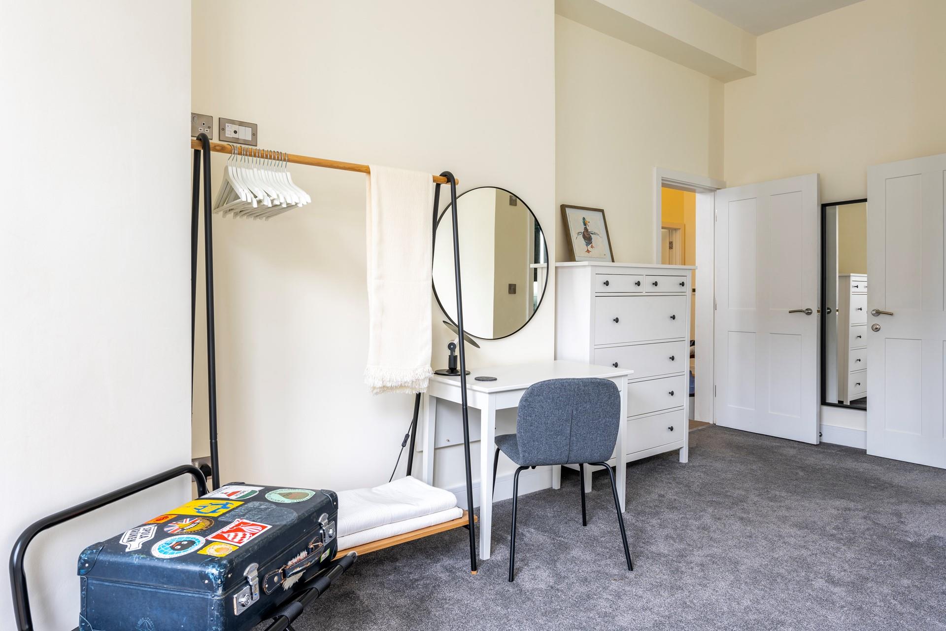 There is plenty of hanging space and a dressing table for getting ready.