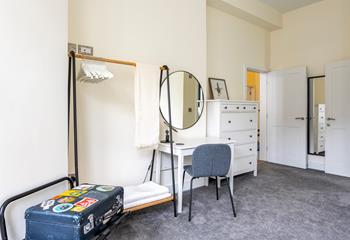 There is plenty of hanging space and a dressing table for getting ready.