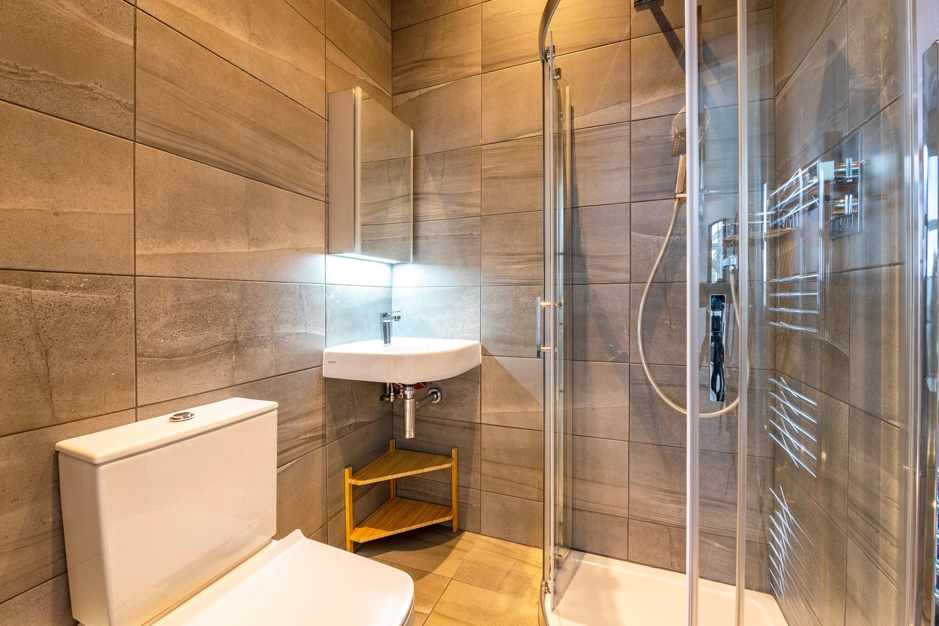 The modern en suite shower room is perfect for washing off sandy toes.
