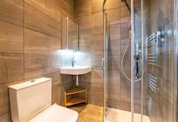 The modern en suite shower room is perfect for washing off sandy toes.