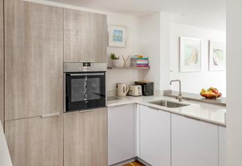 The kitchen is modern and fully equipped for cooking up a storm.