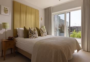 Bedroom 3 is on the ground floor, boasting a comfortable king size bed and doors out to the garden.