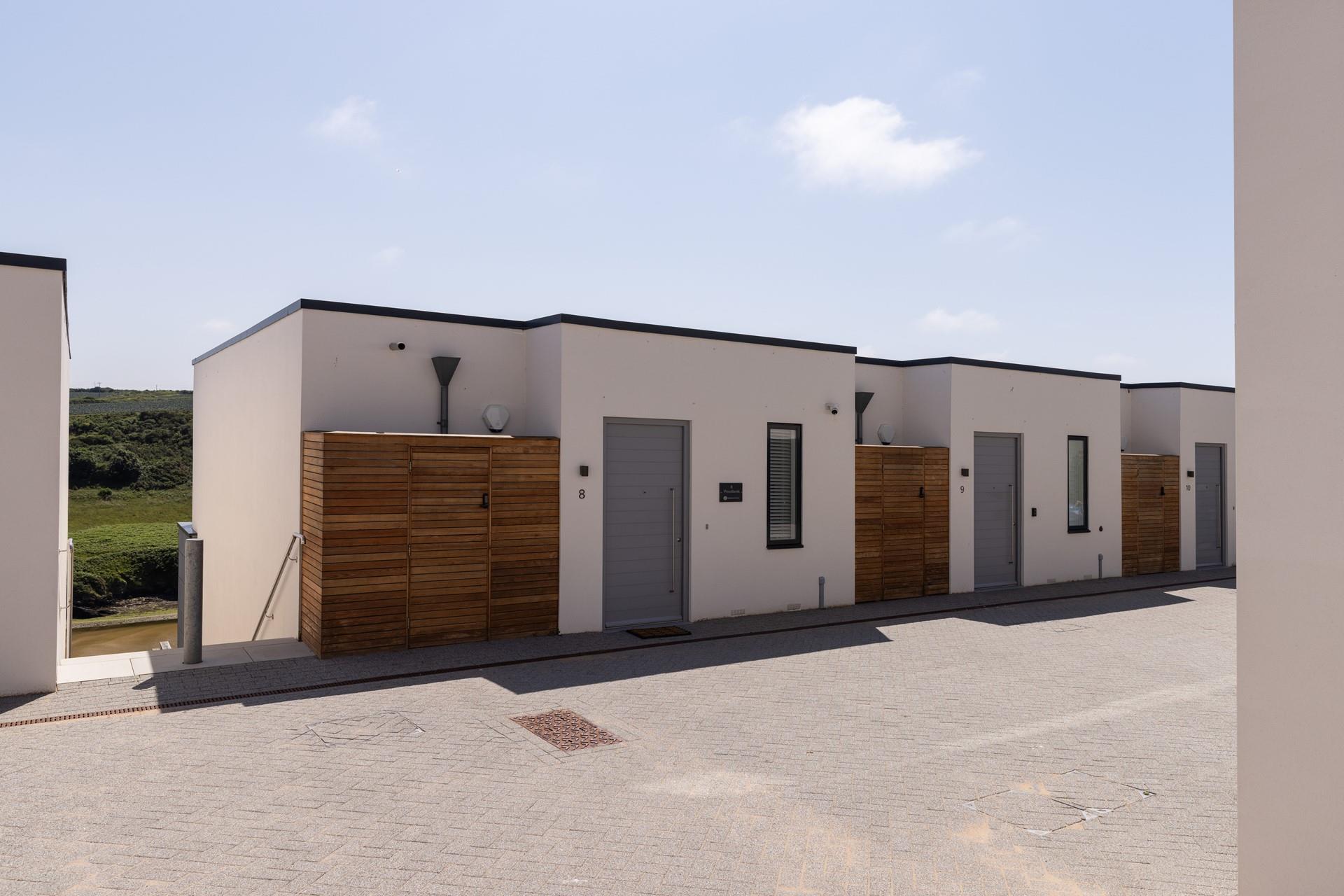 From the car port, you're a few steps from the entrance at 8 Woodlands.