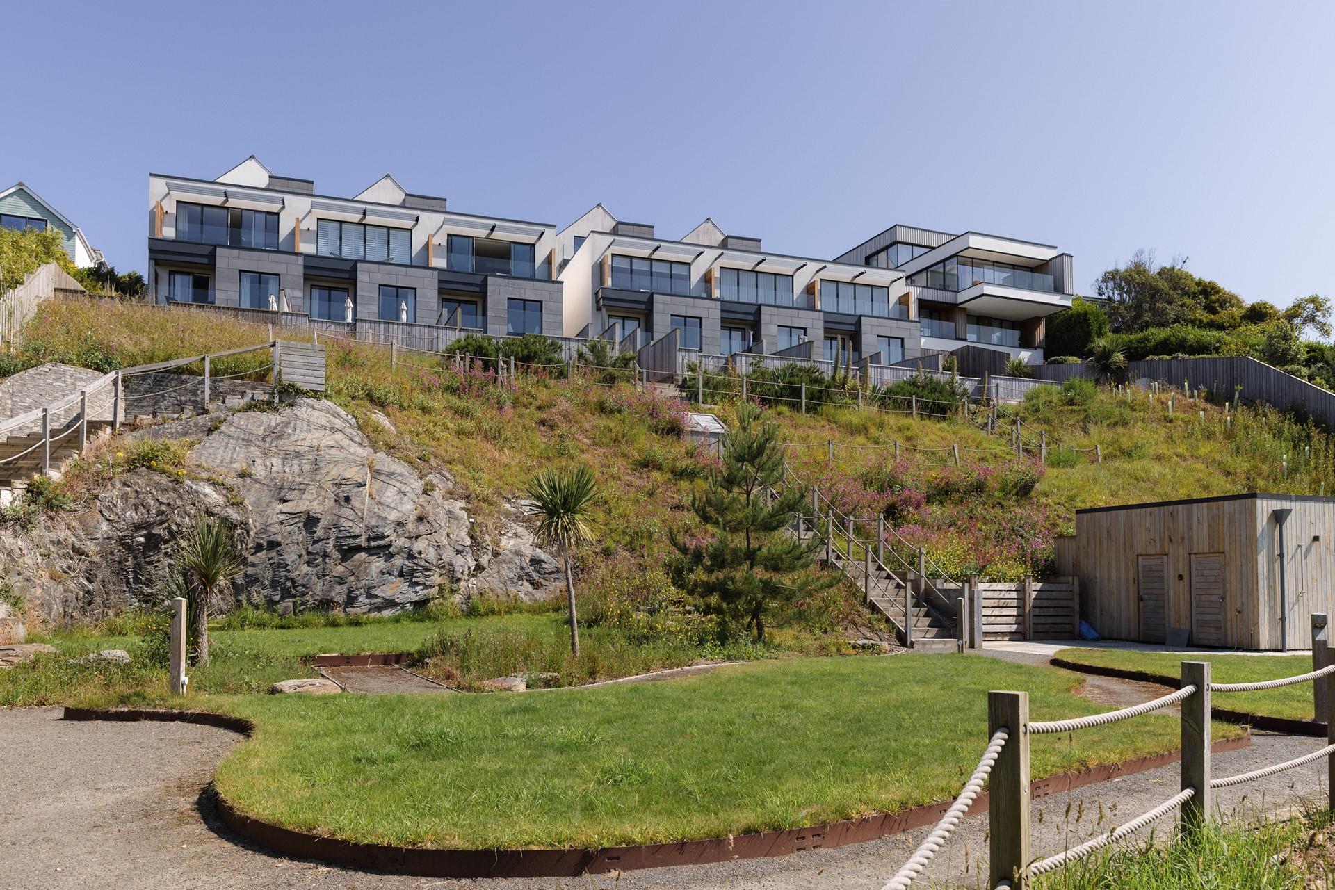 There are landscaped communal grounds with an outdoor shower that lead down to the shoreline.