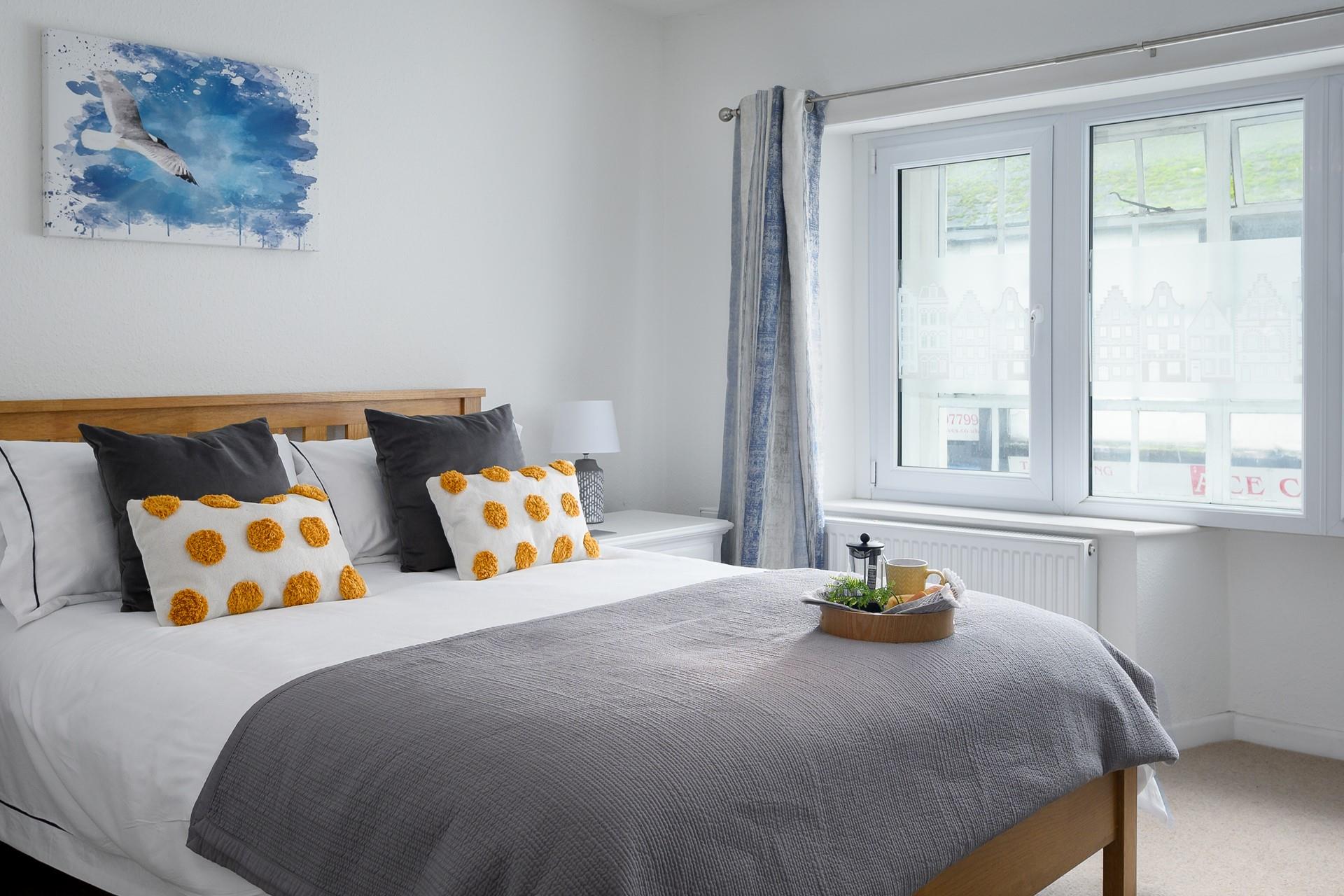 The simple yet stylish decor makes bedroom 2 a calming space to drift off.