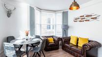 Sink into the armchair and put your feet up in the cheerful sitting room.