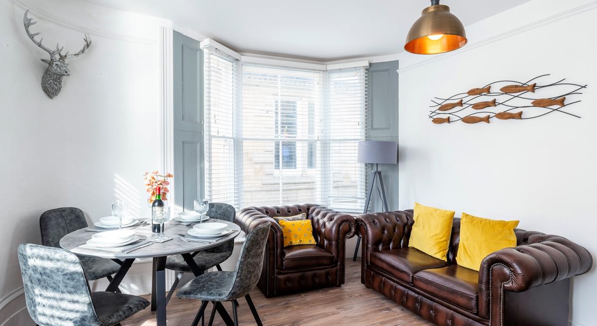 Sink into the armchair and put your feet up in the cheerful sitting room.