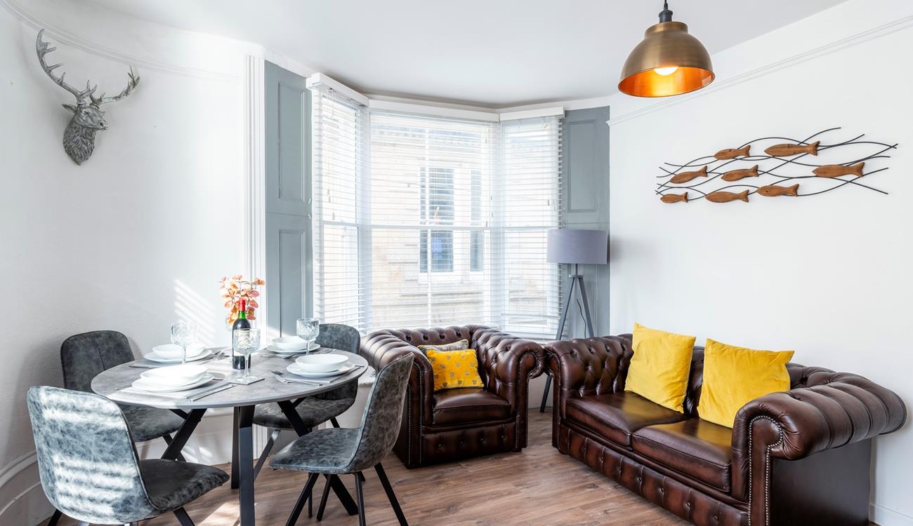 Sink into the armchair and put your feet up in the cheerful sitting room.