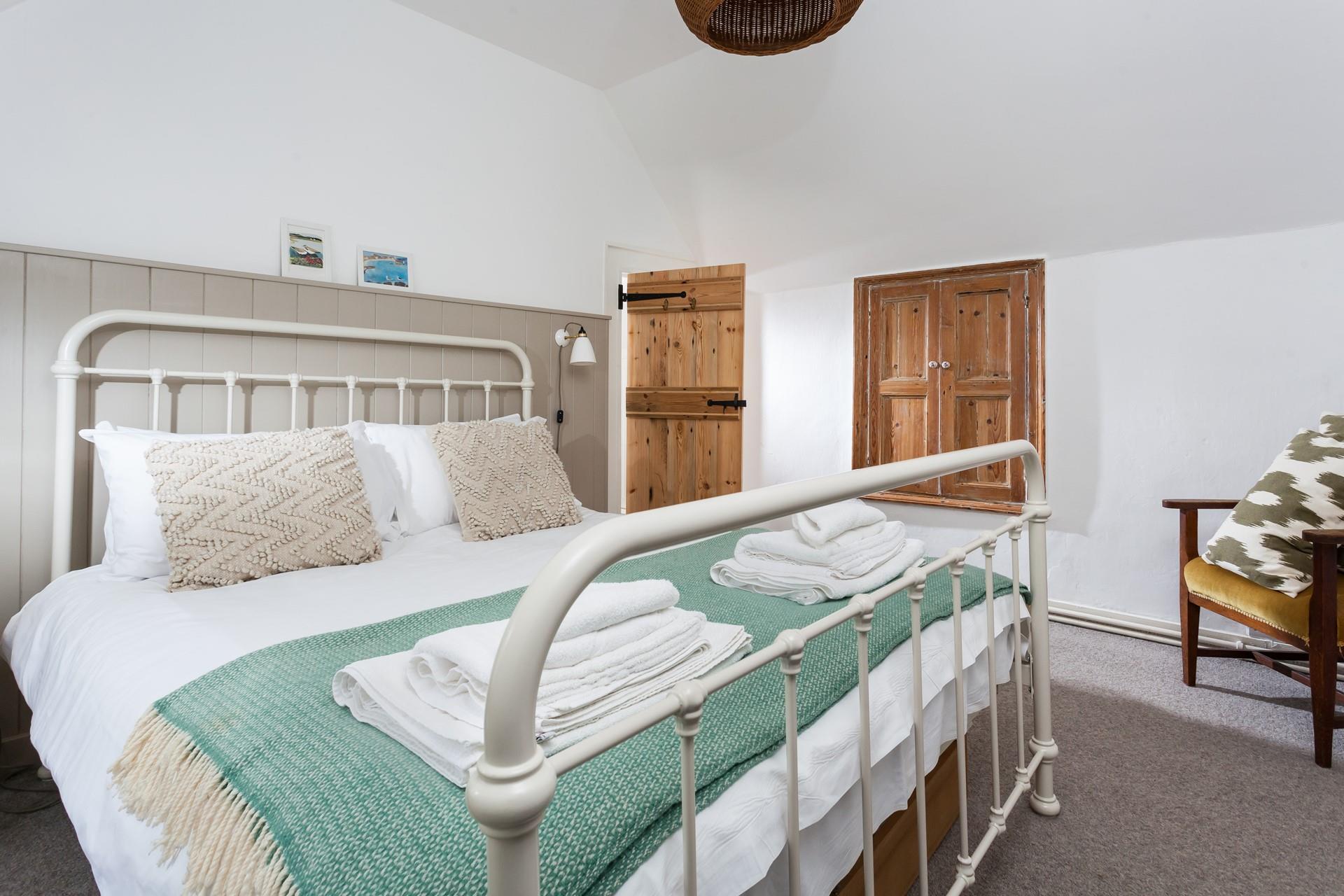 Fluffy white towels and soft sheets await you in bedroom 1.