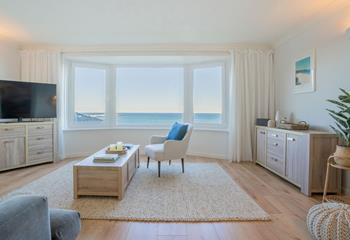 The sitting room is stylishly decorated with stunning views of Carbis Bay.
