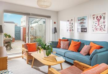 The open plan living area is awash with vibrant colour and homely touches. 