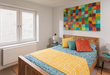 The bright and colourful bedroom offers guests a comfortable night's sleep after busy days exploring.