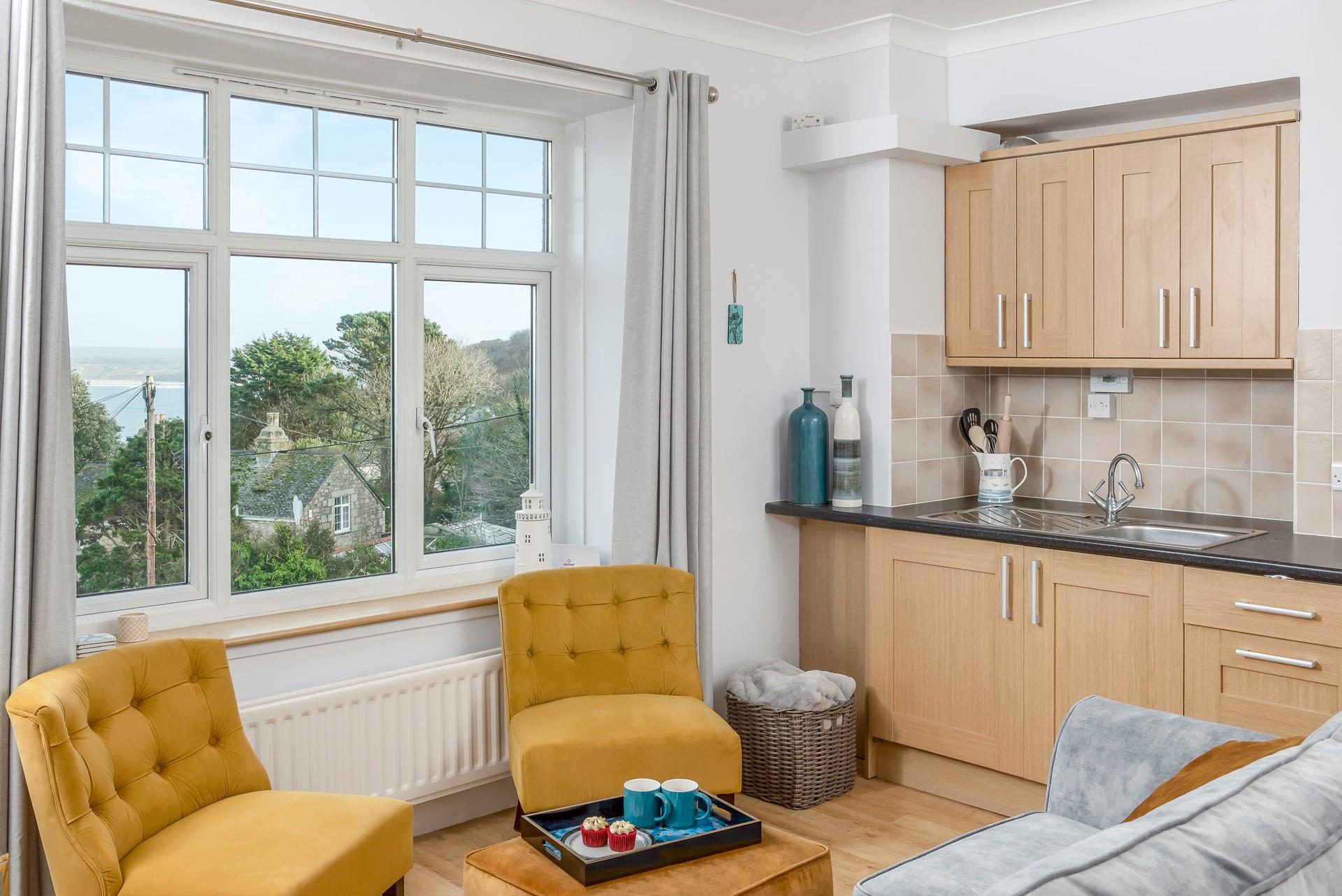 Sink into the sofa with a cup of tea and enjoy the sea views peeping through the trees.