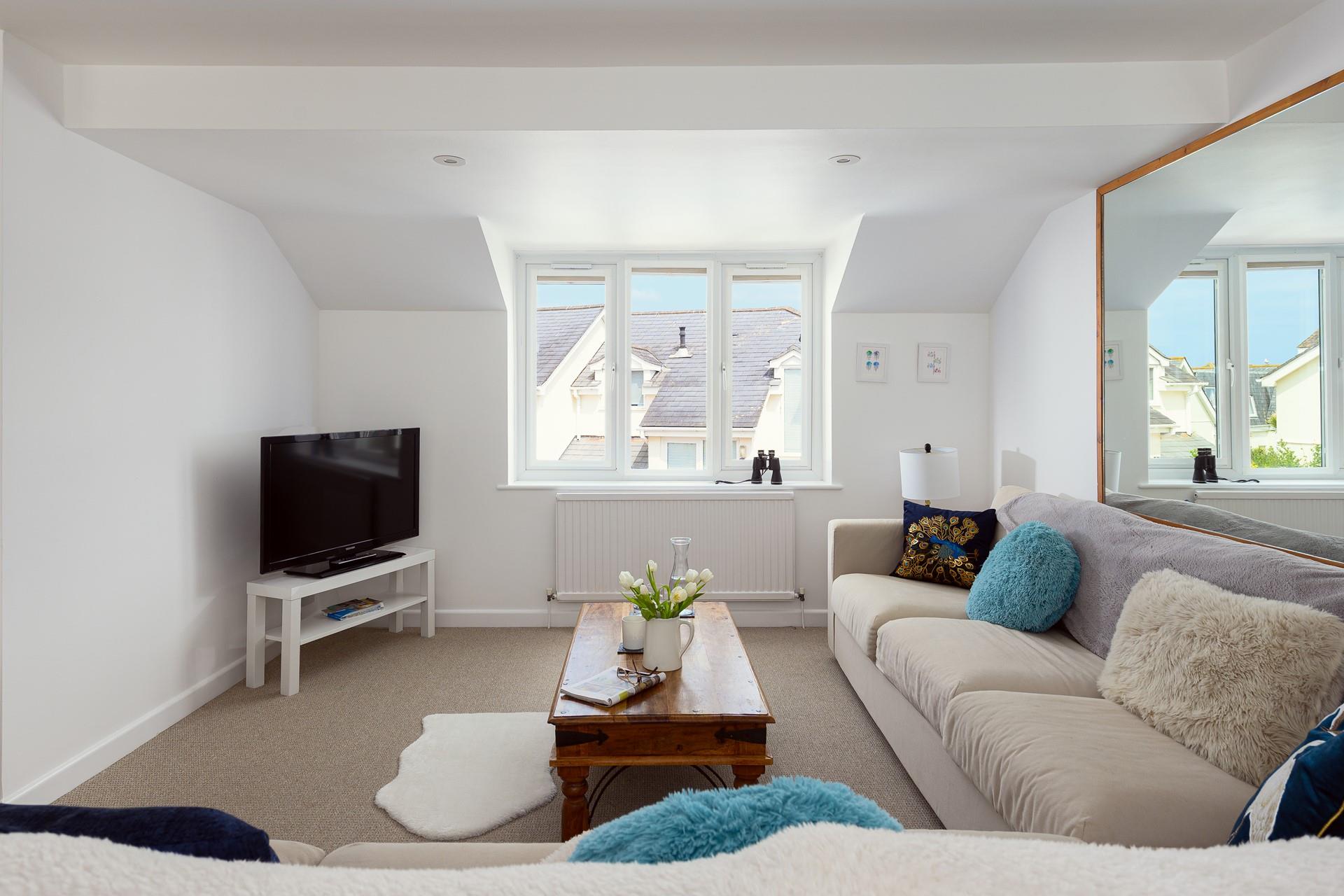 Enjoy the sea glimpses from the cosy sitting room.