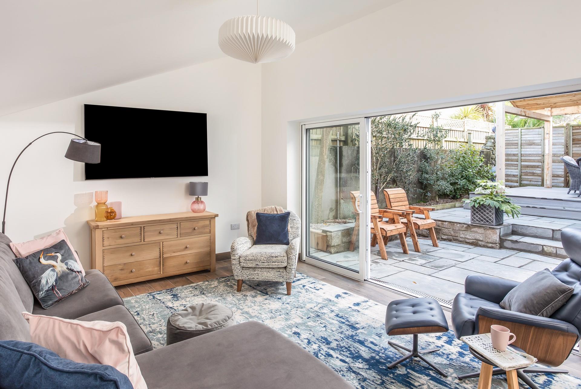 Slide open the patio doors to let the fresh summer breeze into the cosy sitting room.