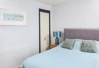 The calming blue decor reflects the apartment's close proximity to the sea.