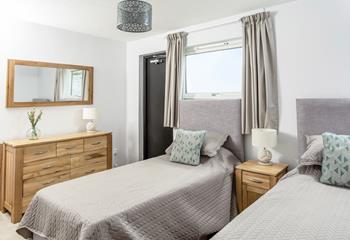 Bedroom 2 has twin beds to cosy into after a day exploring the Camel Trail by bike.