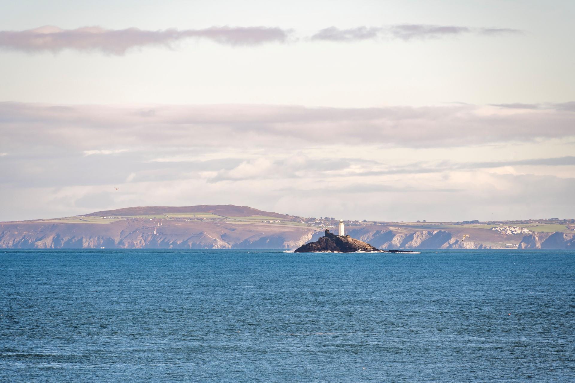 Watch the waves rolling onto the beach as you gaze over to Godrevy Lighthouse.