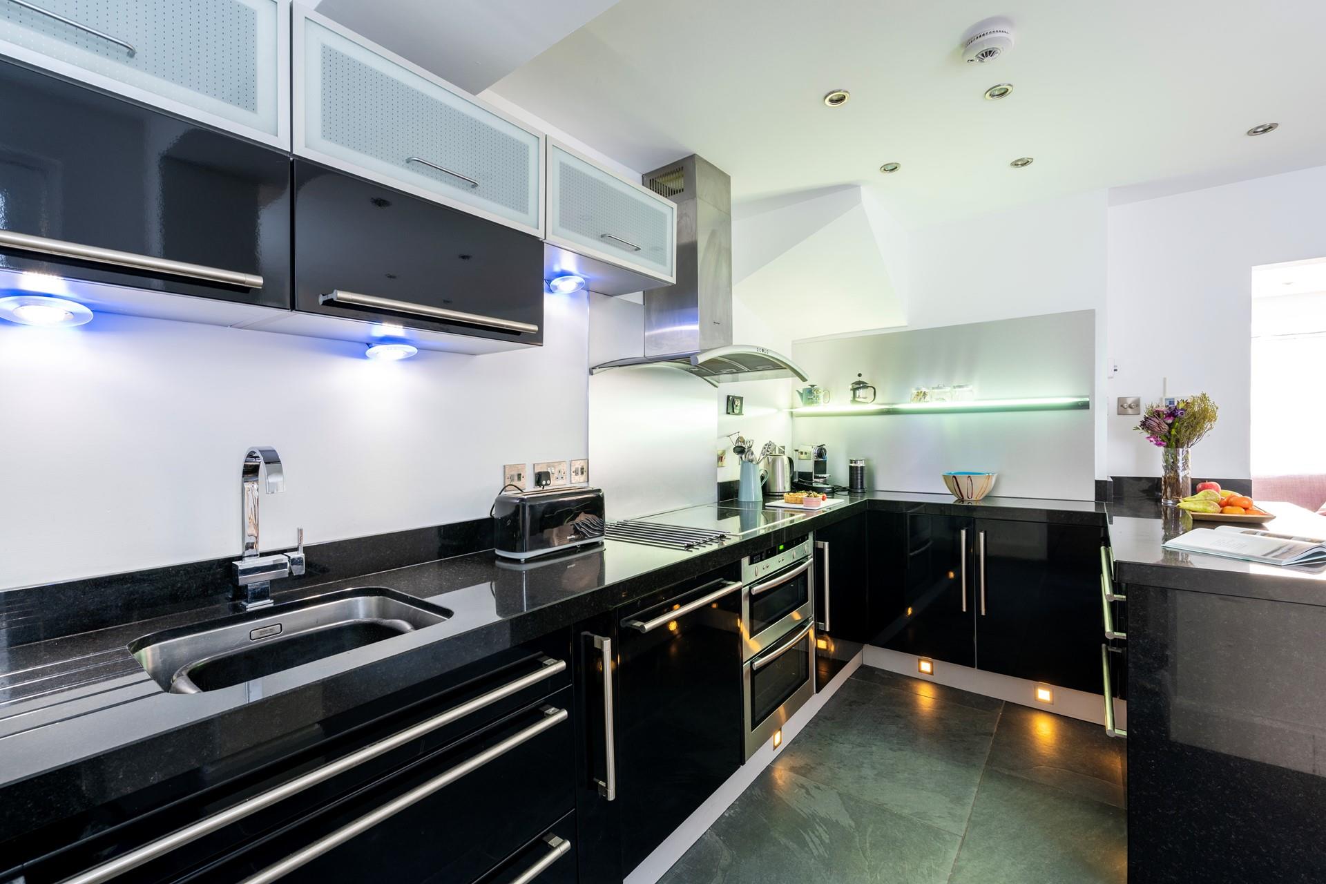 Under cupboard lights give the kitchen a modern and stylish feel.