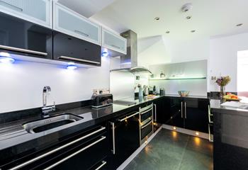 Under cupboard lights give the kitchen a modern and stylish feel.