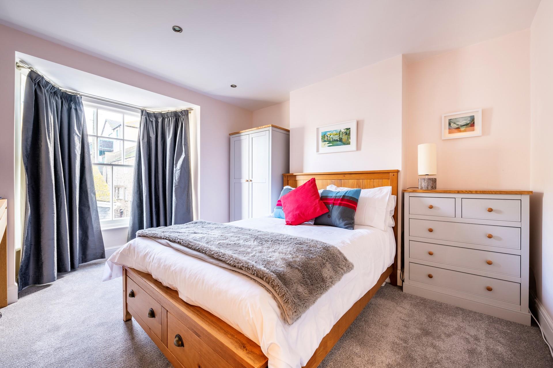 Bedroom 2 has a king size bed and modern furnishings making for a comfortable base to rest your head.