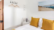 The yellow decor perfectly reflects that the cottage is just one mile from the beach!