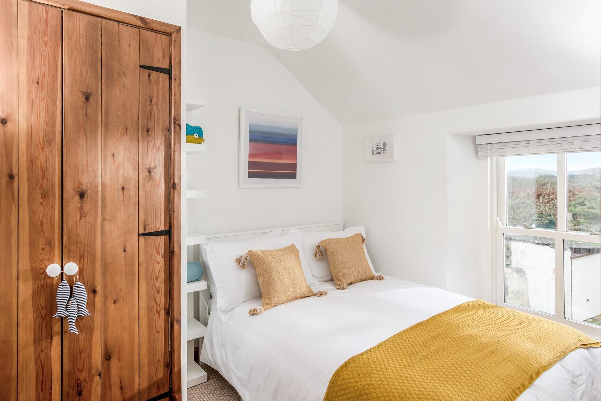 Bedroom 3 has a double bed and ample storage space.