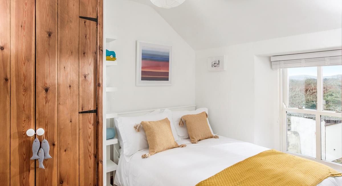 Bedroom 3 has a double bed and ample storage space.