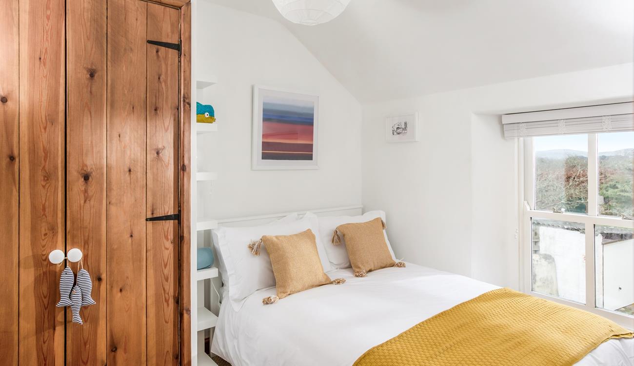 Bedroom 3 has a double bed and ample storage space.