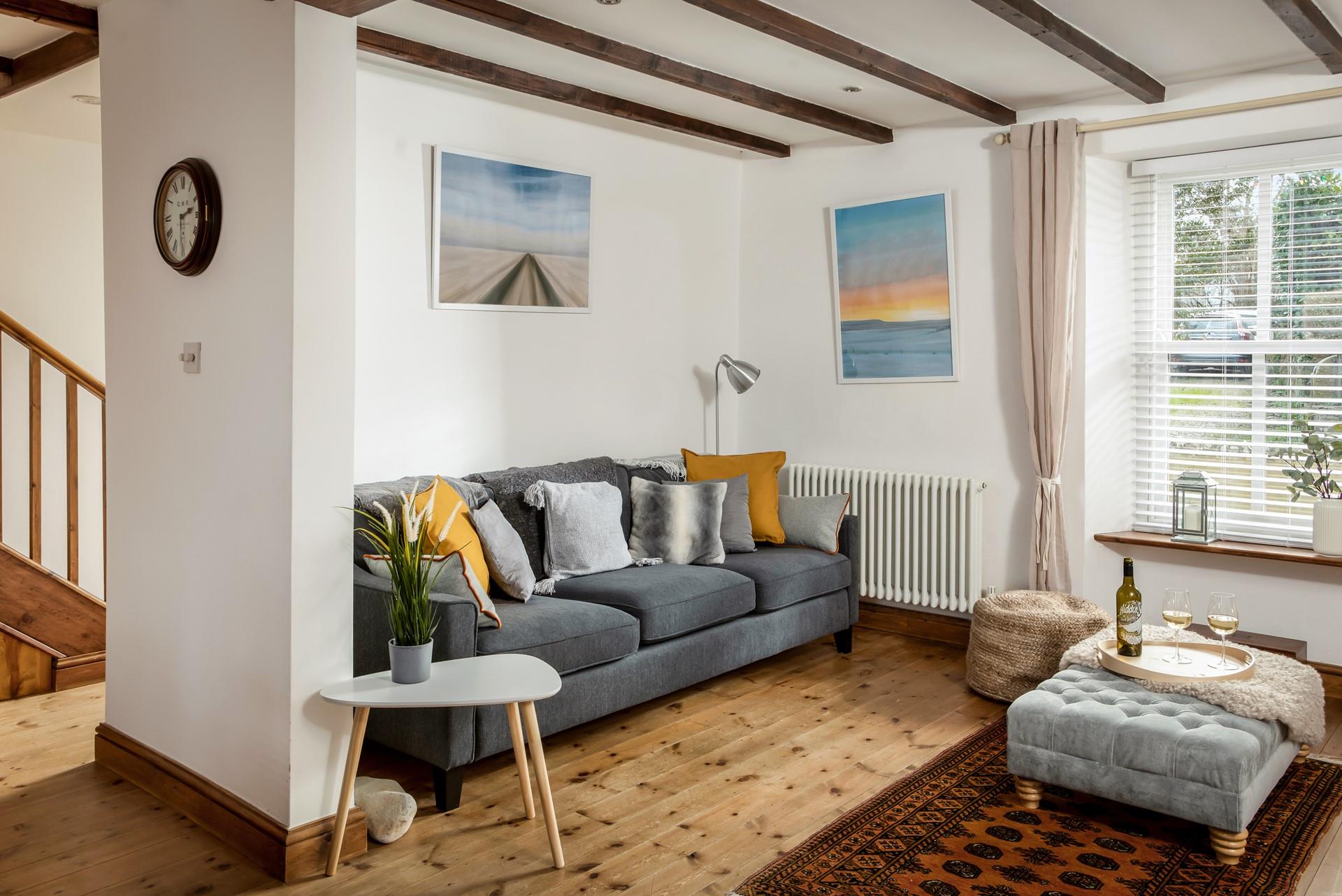 Relax on the sumptuous sofa with a chilled glass of wine after a day exploring Porthleven nearby.