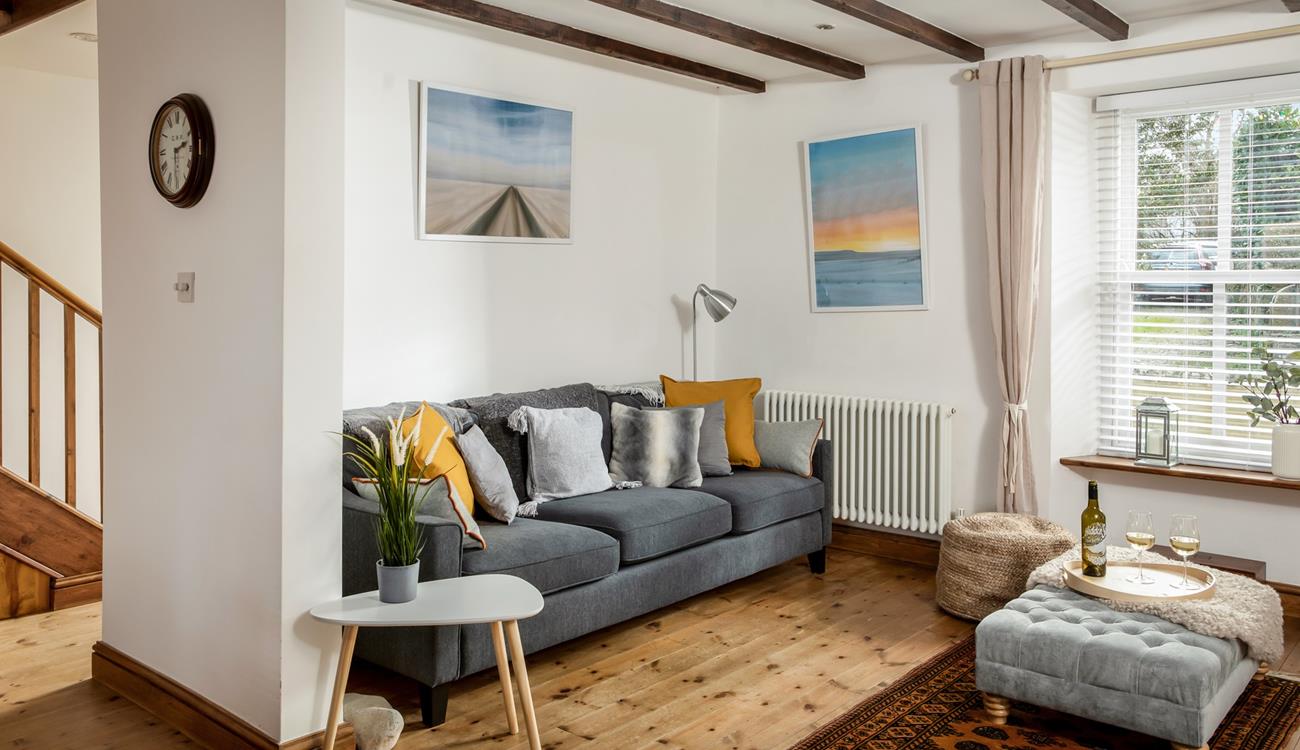 Relax on the sumptuous sofa with a chilled glass of wine after a day exploring Porthleven nearby.