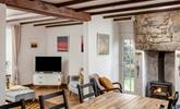 The bright open plan living space at Trewinel Cottage with a door to the enclosed garden.  - Thumbnail Image