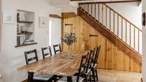 Sit around the dining table ready to devour a tasty meal.
