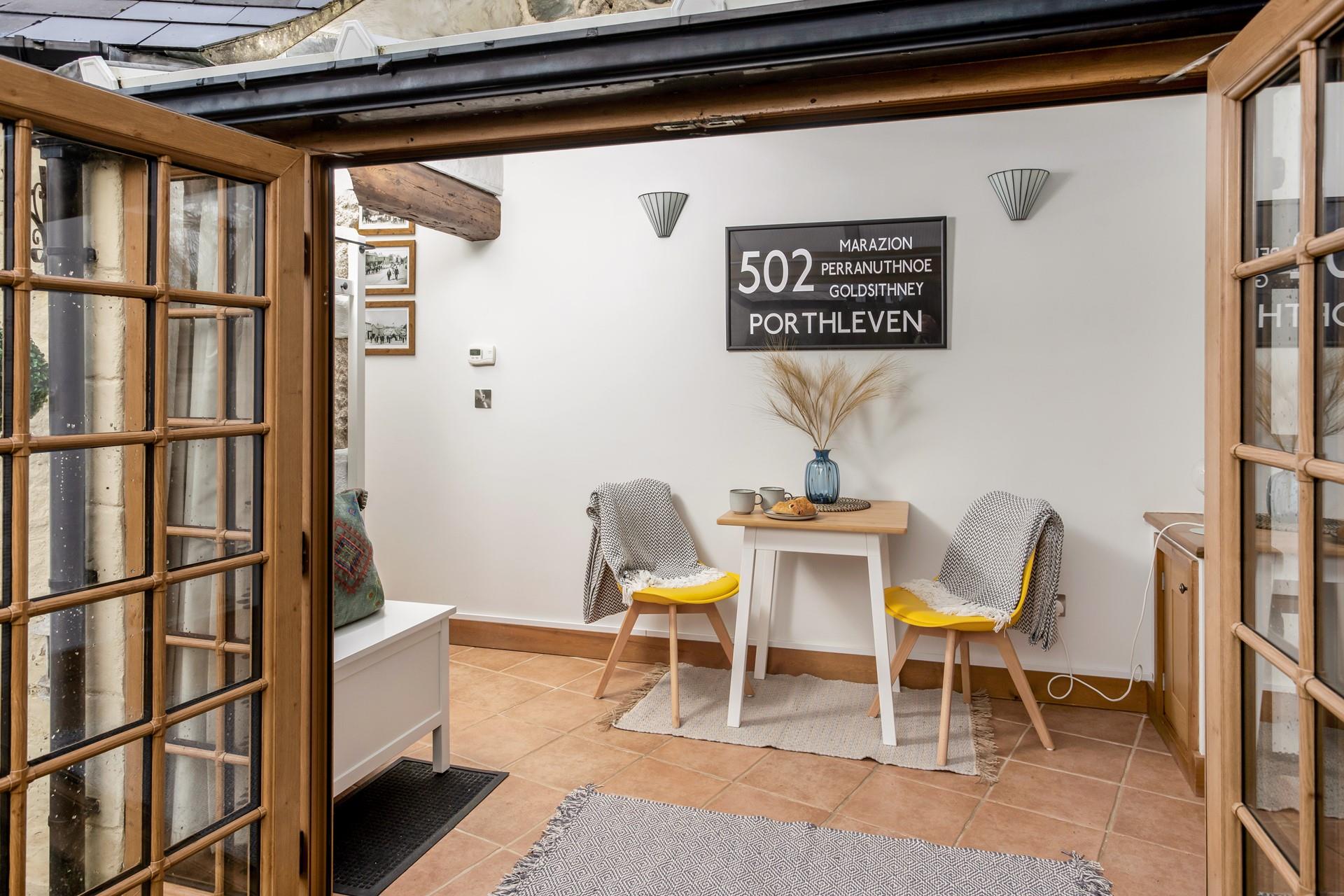 The sunroom offers space for a peaceful morning coffee.
