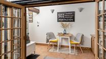 The sunroom offers space for a peaceful morning coffee.