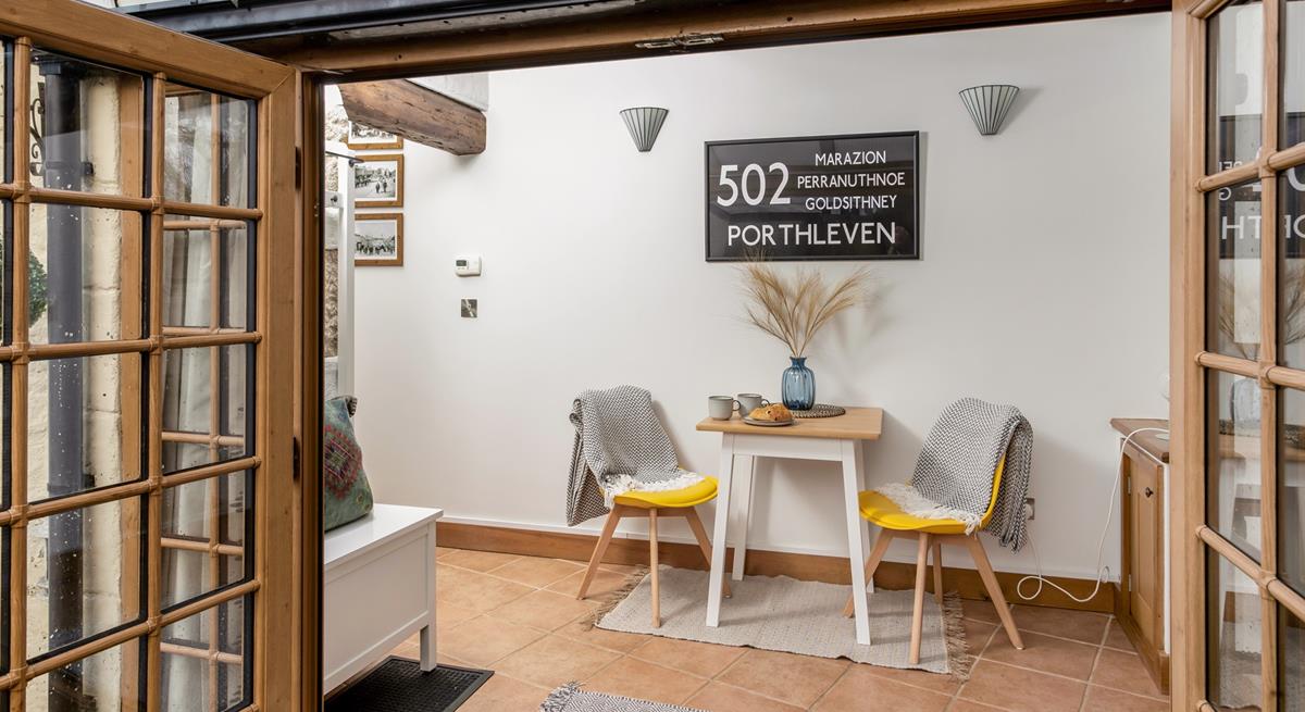 The sunroom offers space for a peaceful morning coffee.